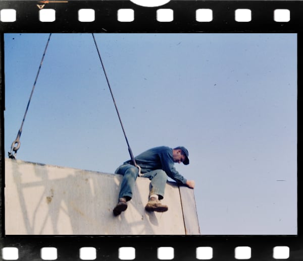 Vintage Slide: Man sitting on top of concrete wall section